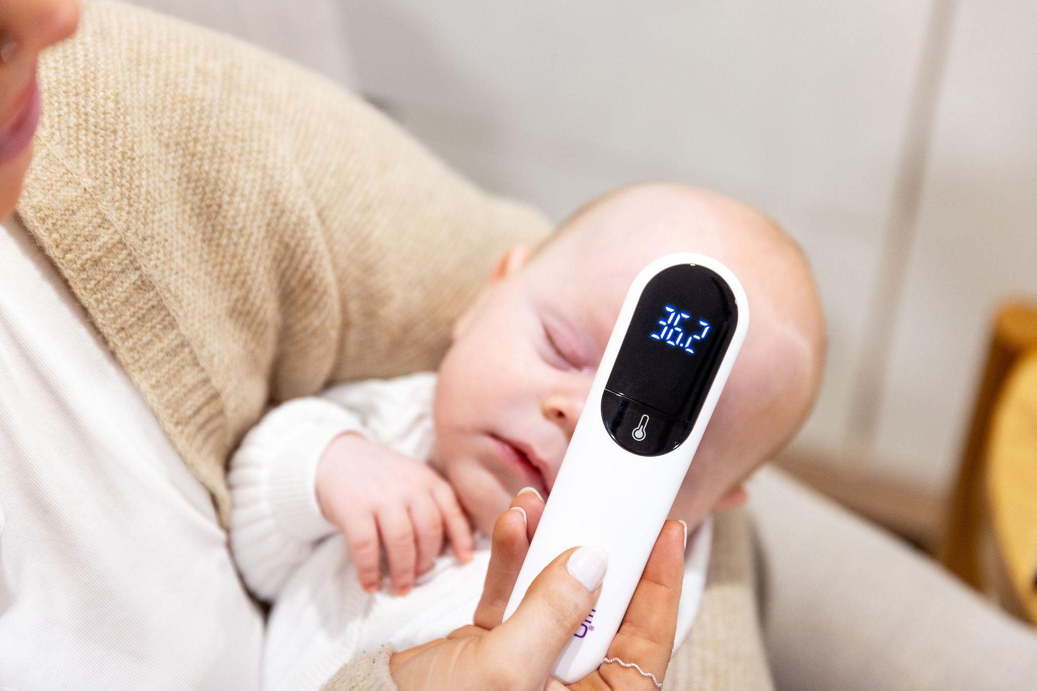 Contactless thermometer used near a sleeping baby